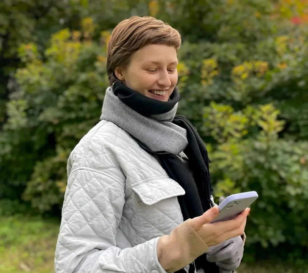 Employee reflecting with phone against open sky
